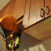 Handy man repairing cupboards